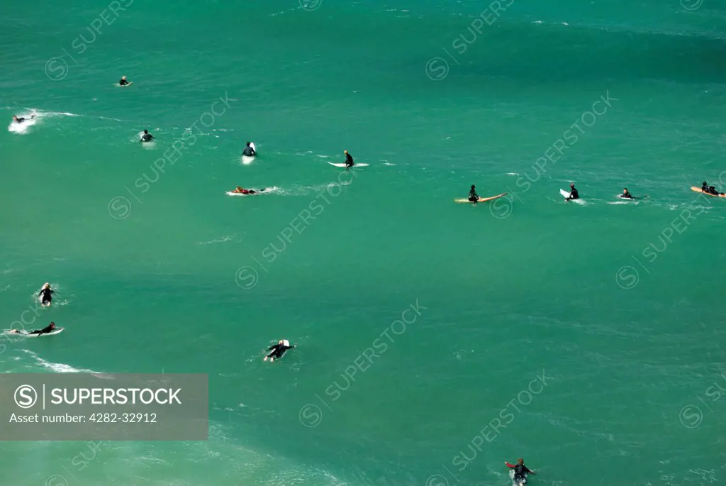 England, Cornwall, Newquay. Surfers in the water at Newquay.