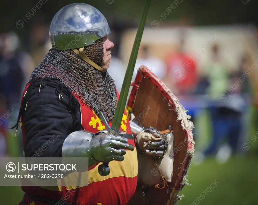 Scotland, Lanarkshire, Lanark. A man in medieval costume prepares for battle at Lanark 2011, Scotland's Festival of History.