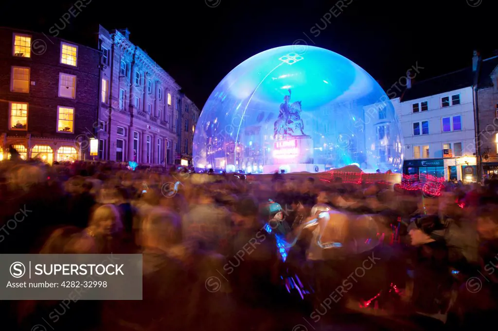 England, County Durham, Durham. People gather around the I Love Durham snow-dome during the 2011 Durham Lumiere Festival.