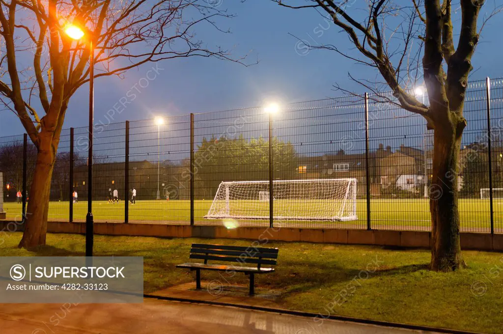 England, London, Islington. Evening atmospheric view of a playing-field in Wittington Park.