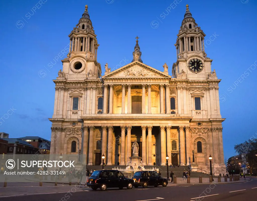 England, London, City of London. The facade of St. Paul's Cathedral lit up as the evening darkness sets in.