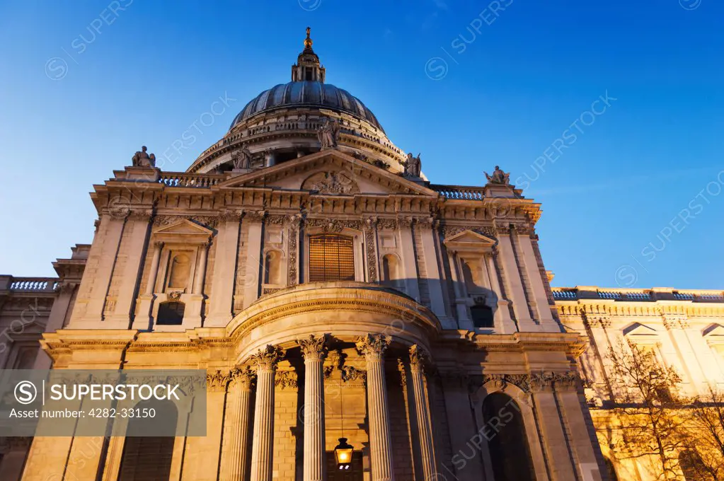 England, London, City of London. Detail of St. Paul's Cathedral lit up as the evening darkness sets in.