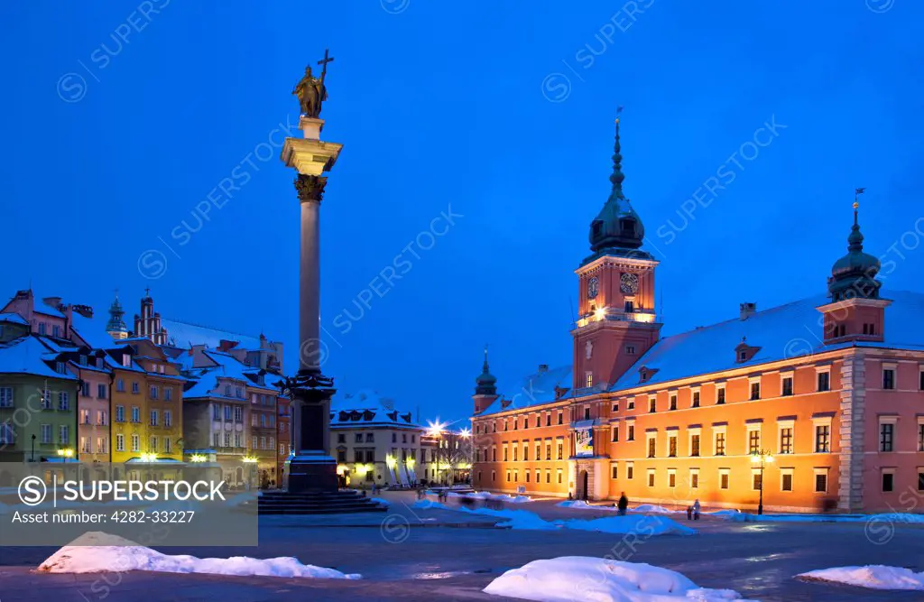Poland, Mazovia Province, Warsaw. Winter twilight in Castle Square in Warsaw with Zygmunt's Column and the Royal Castle illuminated.
