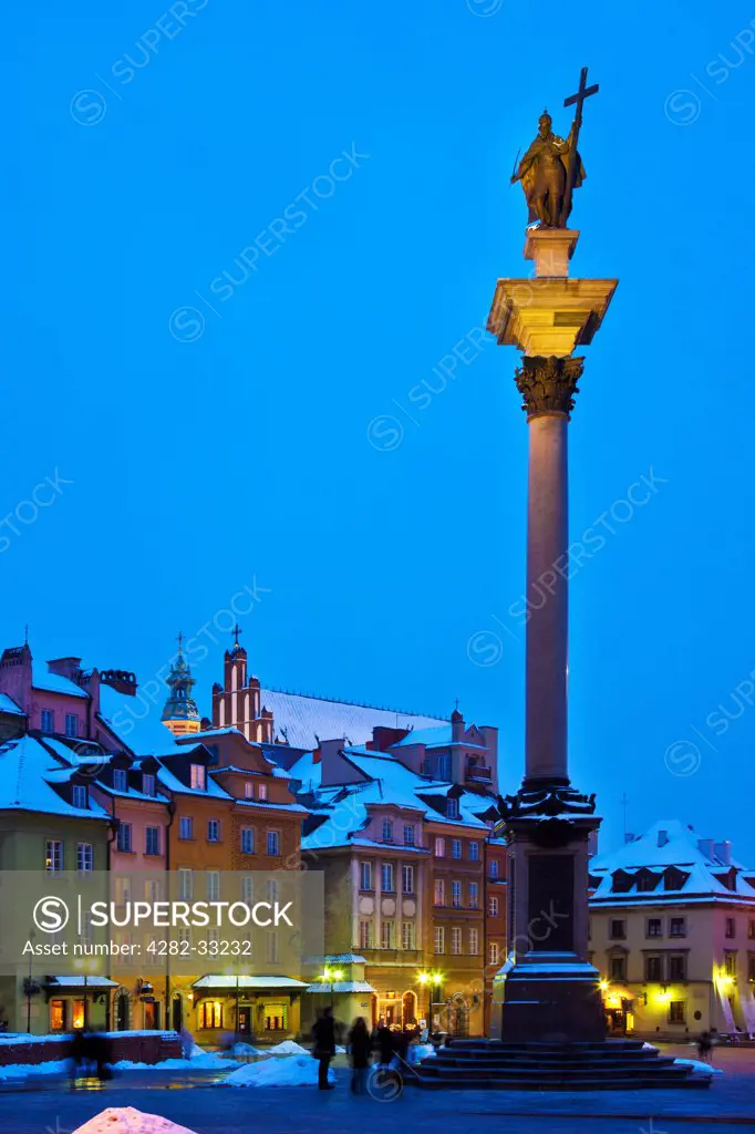 Poland, Mazovia Province, Warsaw. Winter twilight in Castle Square in Warsaw with Zygmunt's Column on the right.