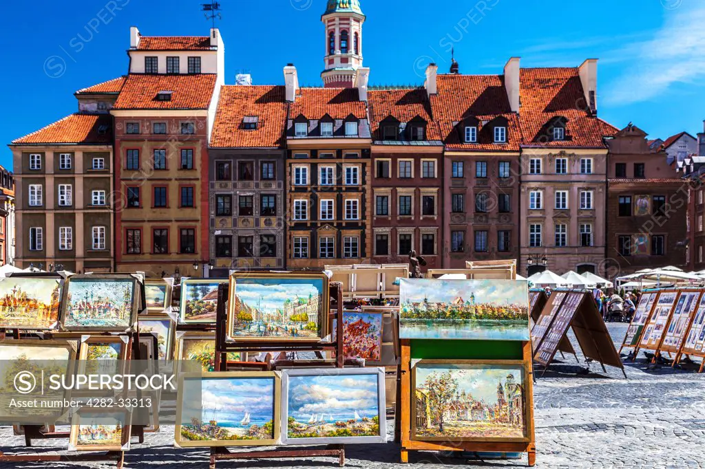 Poland, Mazovia Province, Warsaw. Open air display of paintings for sale to tourists in Stary Rynek in Warsaw.