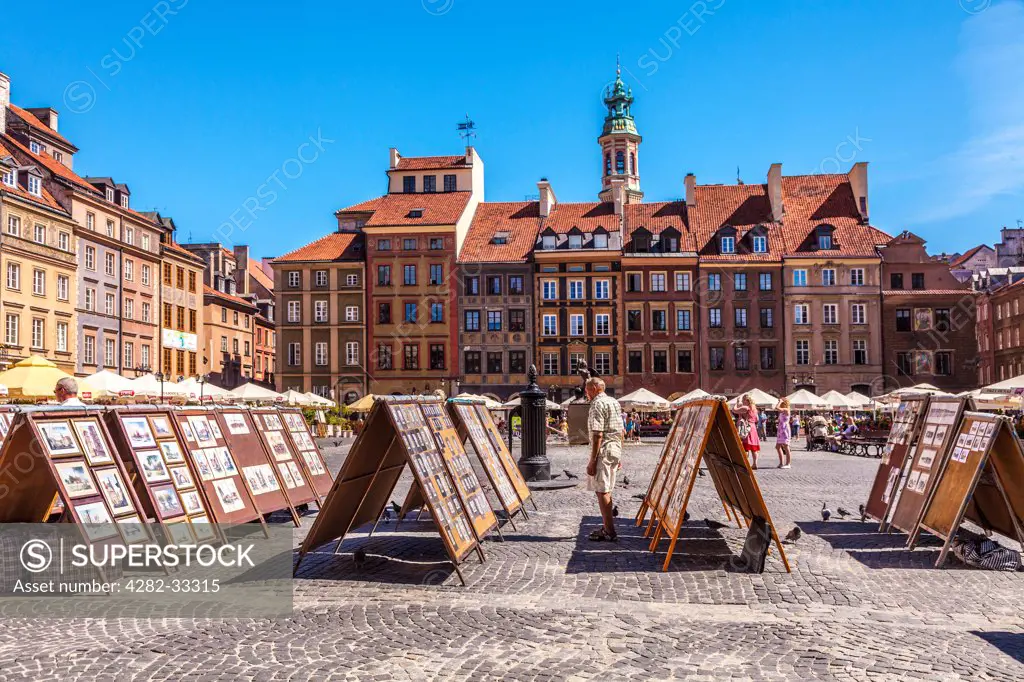 Poland, Mazovia Province, Warsaw. Open air display of paintings for sale to tourists in Stary Rynek in Warsaw.