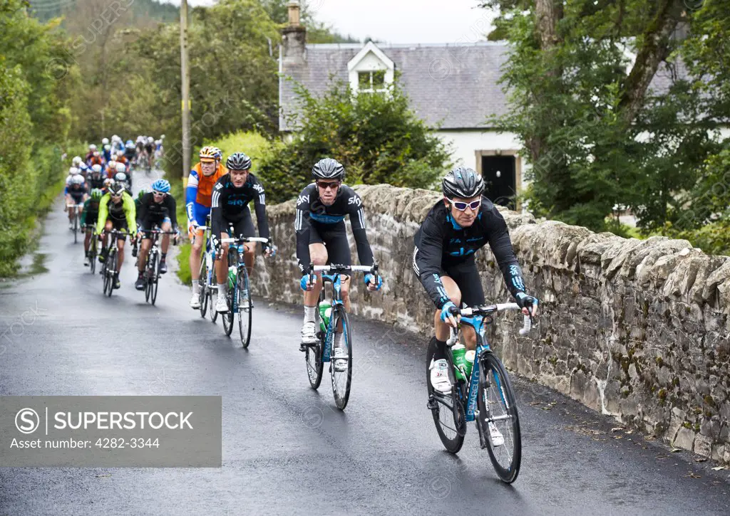 Scotland, Scottish Borders, Tweedsmuir. Geraint Thomas of Sky Professional Cycling Team leads a group of cyclists over the River Tweed at Tweedsmuir on stage one of the 2011 Tour of Britain.