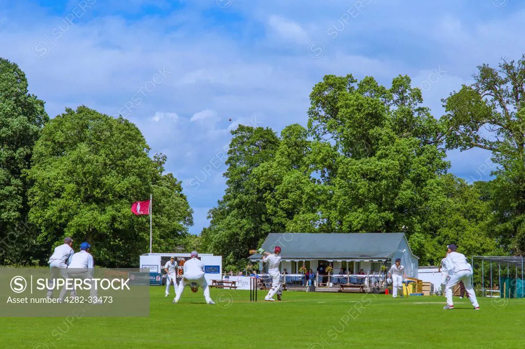 England, Leicestershire, Rothley. The ball flies high in the air as the batsman tries for the boundary.