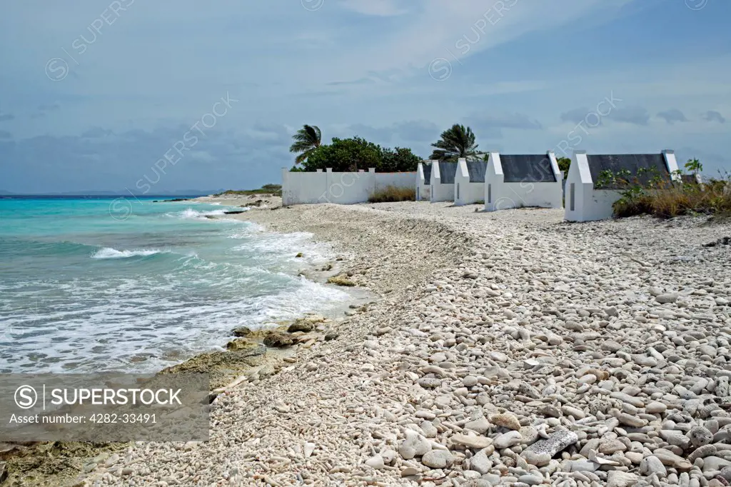 Bonaire, Southern Peninsula, White Slave. A view along the beach and slave huts at the White Slave dive site.