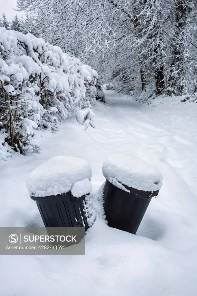 Wales, Monmouthshire, Monmouth. Dustbins covered with snow.