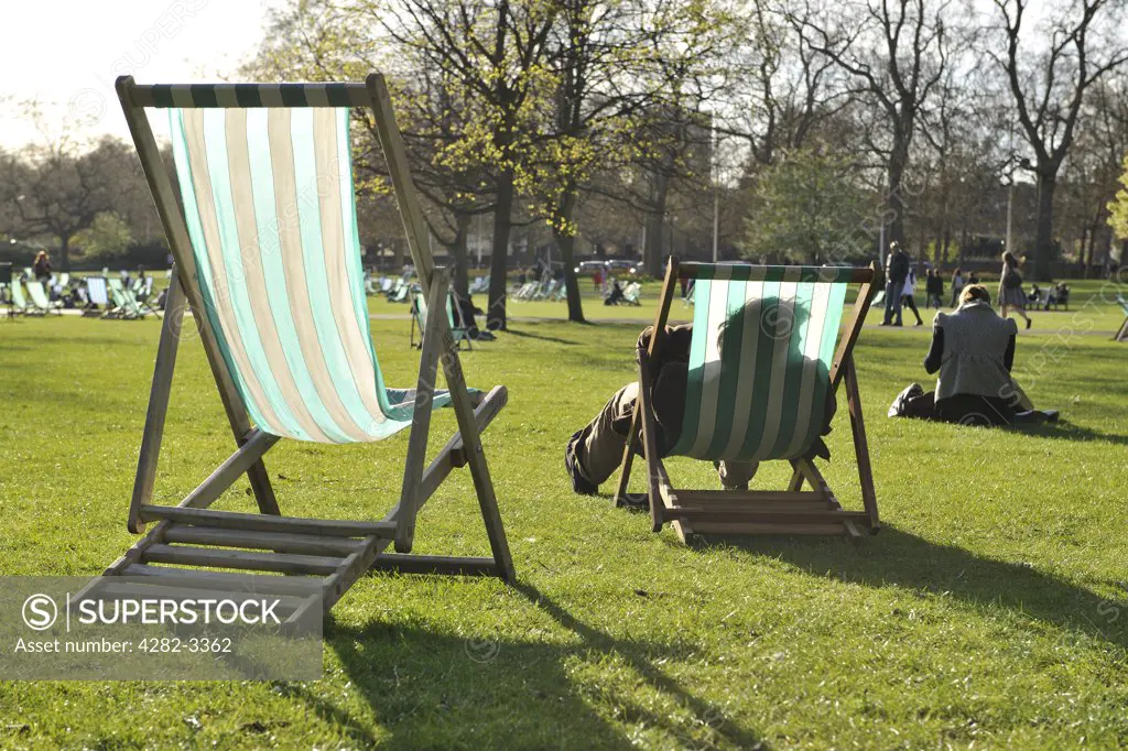 England, London, St. James's Park, London. Deck chairs in the sun in St. James's Park.