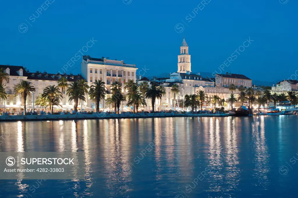 Croatia, Split Dalmatia, Split. Dusk view of the waterfront promenade and tower of the Cathedral of Saint Domnius in the city of Split.