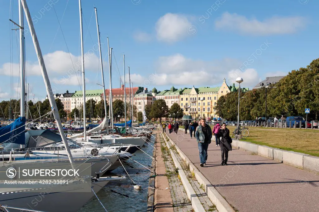 Finland, Uusimaa, Helsinki. A view along Merisatama port and promenade towards the prestigious Merikatu Street in Helsinki.