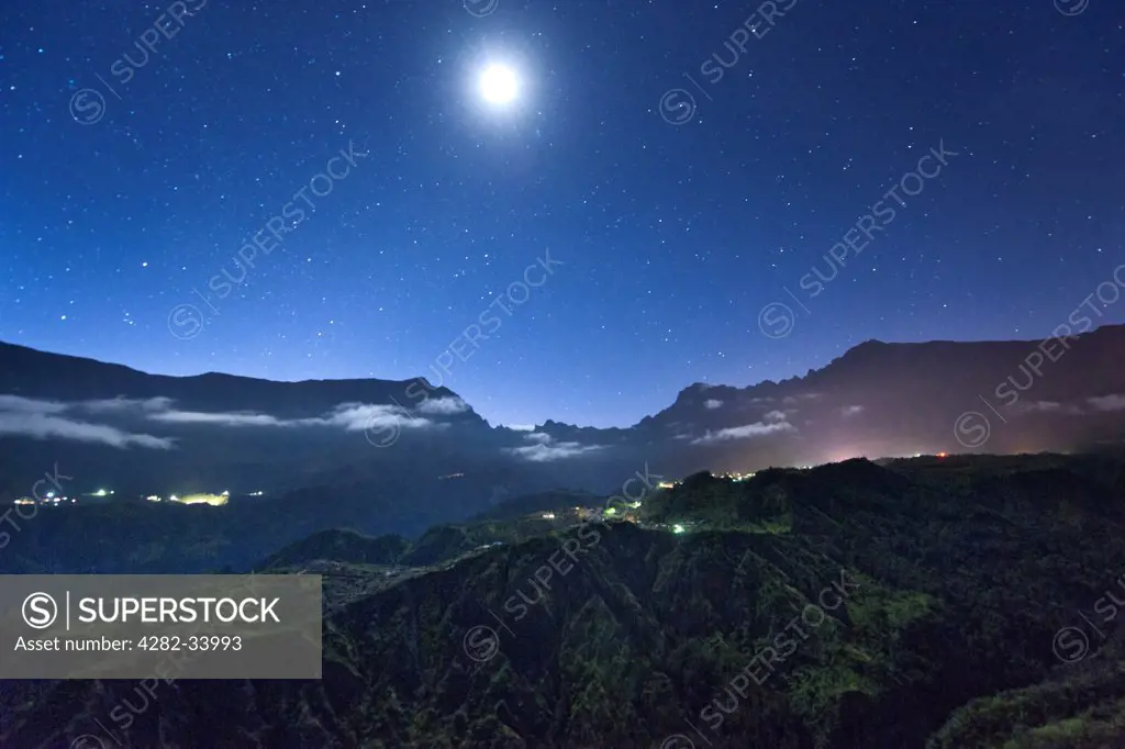 France, Reunion Island, Cirque de Cilaos. The stars and the moon above the Cirque de Cilaos caldera on the French island of Reunion in the Indian Ocean.
