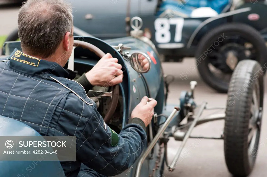 England, Gloucestershire, Prescott. Driver with his vintage Bugatti car at a hill climb event at Prescott.