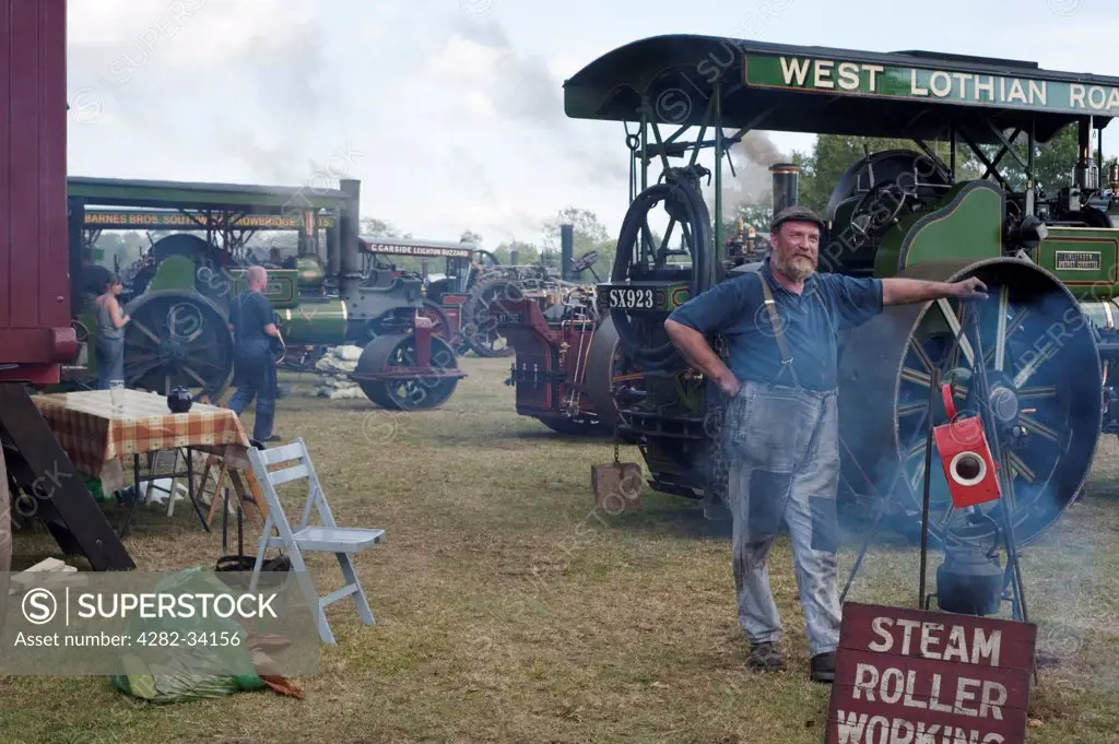 England, Gloucestershire, Fairford. An traction engine driver at a Steam Rally in the Cotswolds.