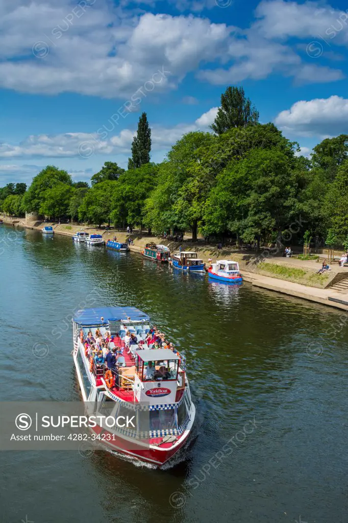 England, North Yorkshire, York. Pleasure craft taking river tours along the River Ouse.