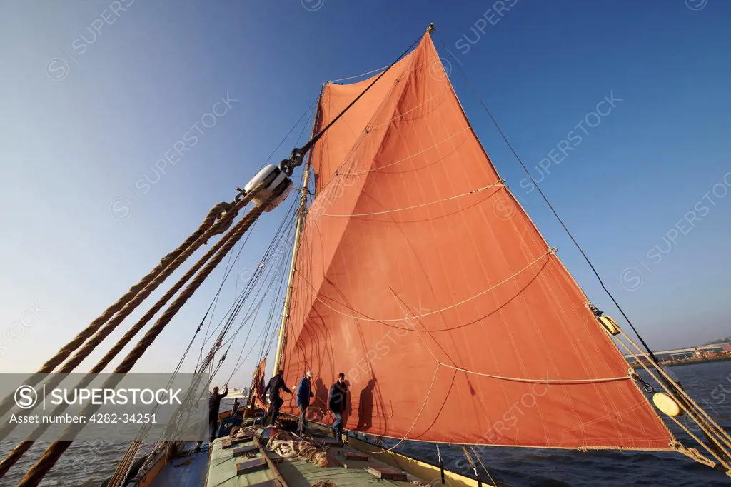 England, Kent, Sheerness. Deckhands work the sails of the Thames sailing barge Edith May while competing in the 2012 Medway Barge Match.