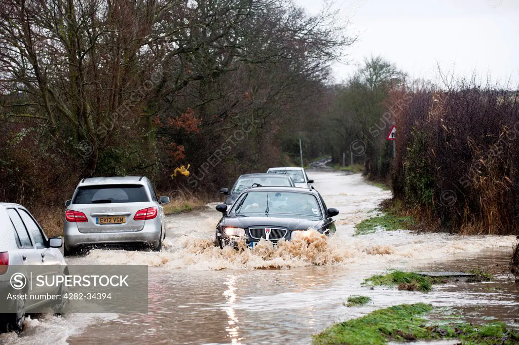 England, Essex, Basildon. Christmas Day drivers struggling to drive through flooded back roads in south east Essex.