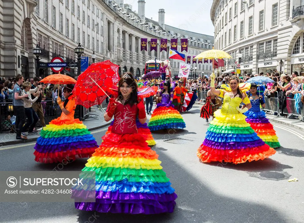 England, London, Regent Street. Colourful Filipino dancers participating in the London Pride parade on Regent Street.