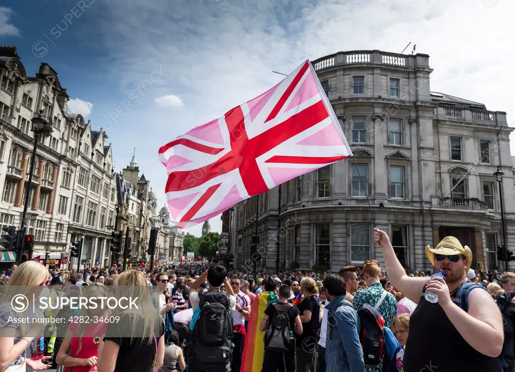 England, London, Regent Street. A flag held aloft by a participant in the London Pride parade.