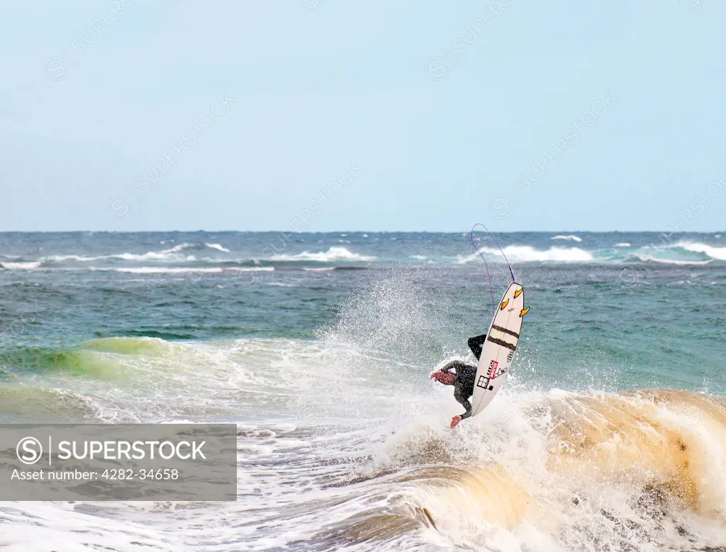 Australia, Western Australia, Margaret River. A surfer off the coast of Margaret River in Western Australia.