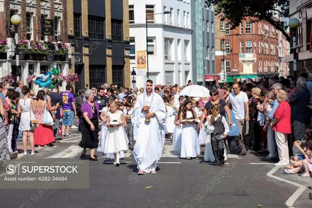 England, London, Clerkenwell. Thousands of people watch as the Procession in Honour of Our Lady of Mount Carmel makes its way along Clerkenwell Road in London.