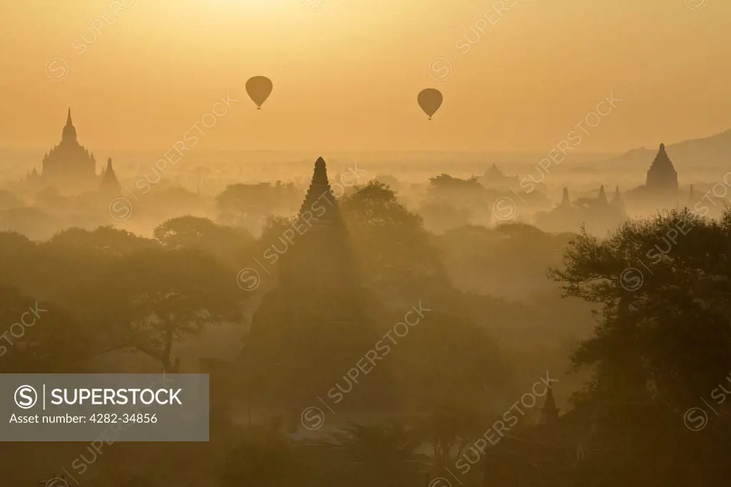Myanmar, Mandalay, Bagan. Sunrise with balloons over the pagodas of Bagan in Myanmar.