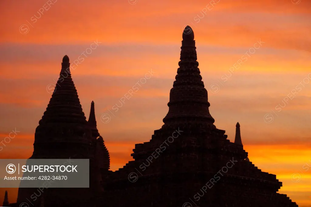 Myanmar, Mandalay, Bagan. Stupas and pagodas of Bagan in Myanmar silhouetted after sunset.