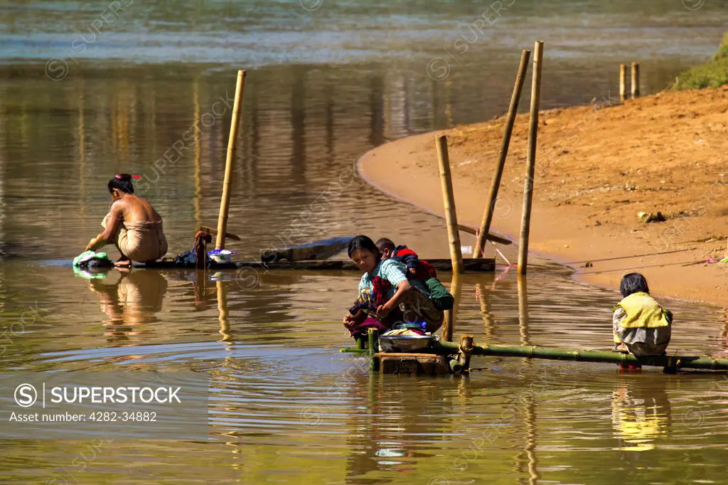 Myanmar, Shan, Shwe Inn Thein. Washday by the river at Inn Thein Village in Myanmar.