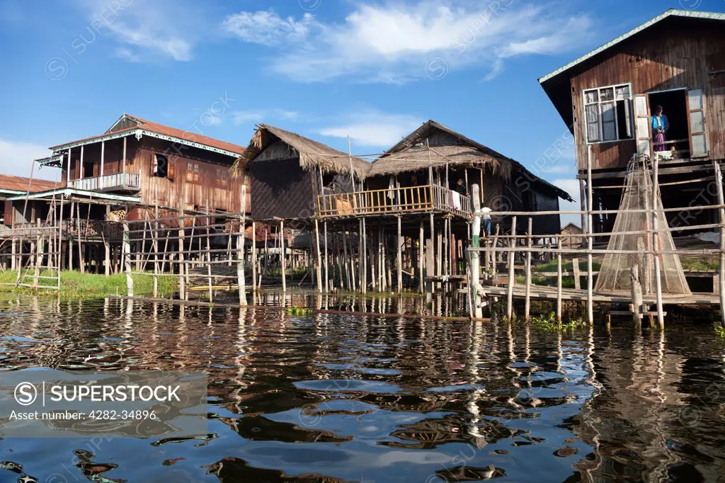 Myanmar, Shan, Lake Inle. A village with houses on stilts by Lake Inle in Myanmar.