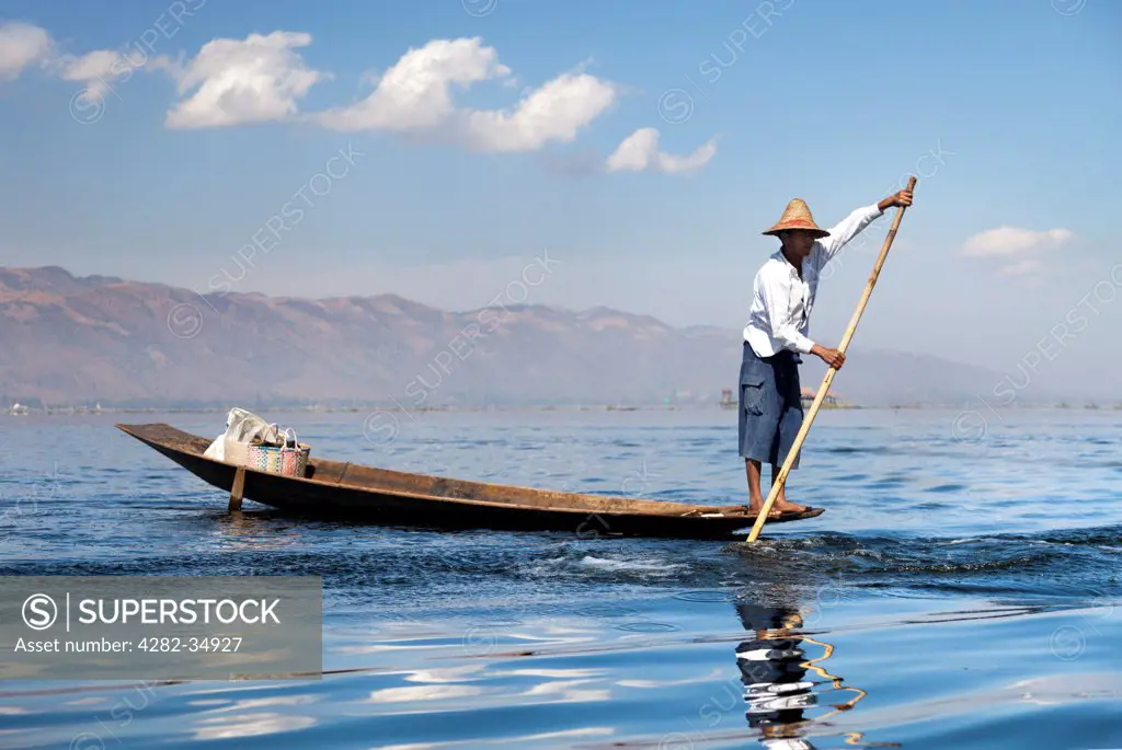 Myanmar, Shan, Lake Inle. A waiting fisherman on Lake Inle in Myanmar.