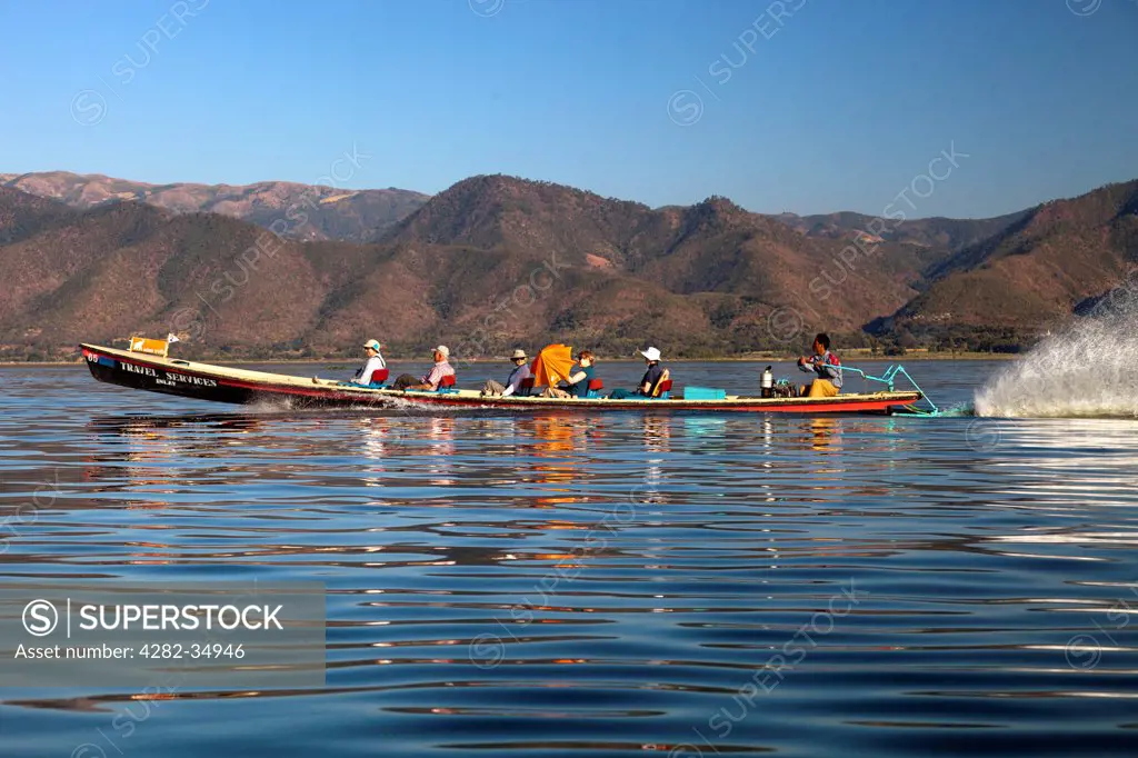 Myanmar, Shan, Lake Inle. A tourist boat cruising Lake Inle in Myanmar.