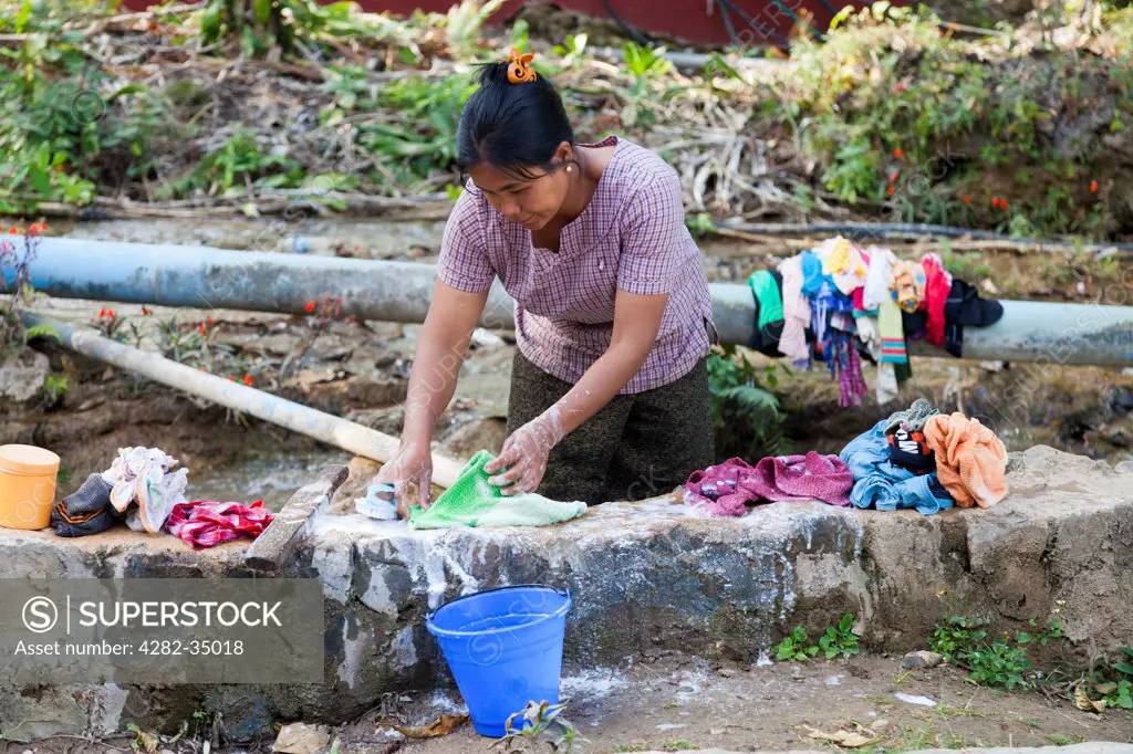 Myanmar, Mandalay, Peik Khyin Myaung . Old-fashioned washday at Peik Khyin Myaung in Myanmar.