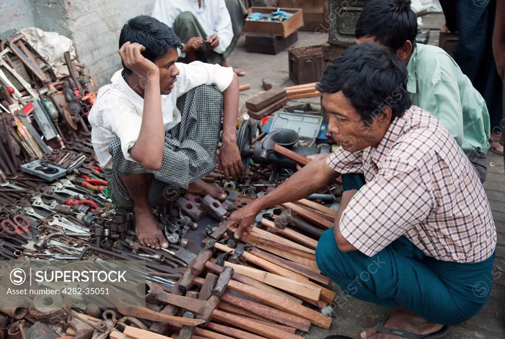 Myanmar, Yangon, Yangon. Man selling tools in the Indian Market  in Yangon in Myanmar.