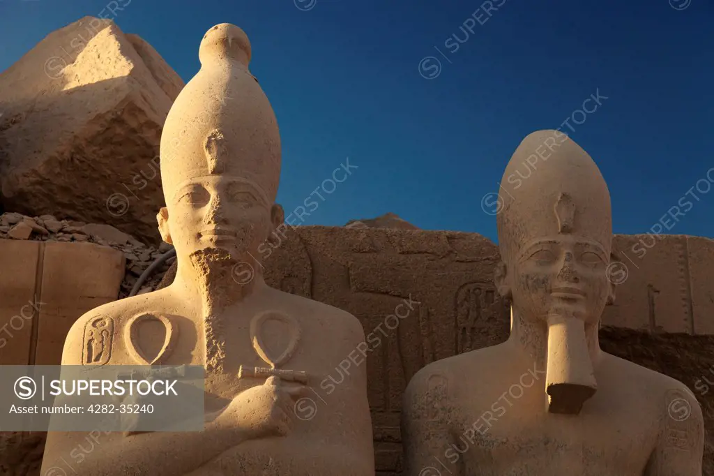 Egypt, Luxor, Karnak Temple. Sunlight settles on statues at Karnak Temple.