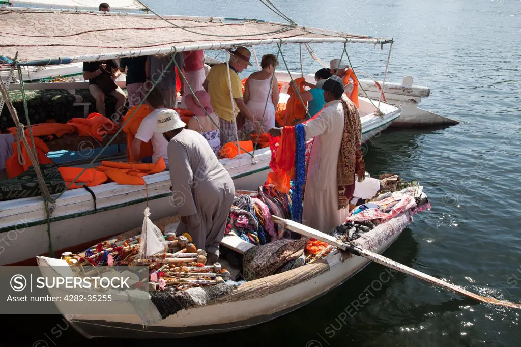 Egypt, Aswan, The Nile. Boat to boat salesman selling souvenirs on The Nile.