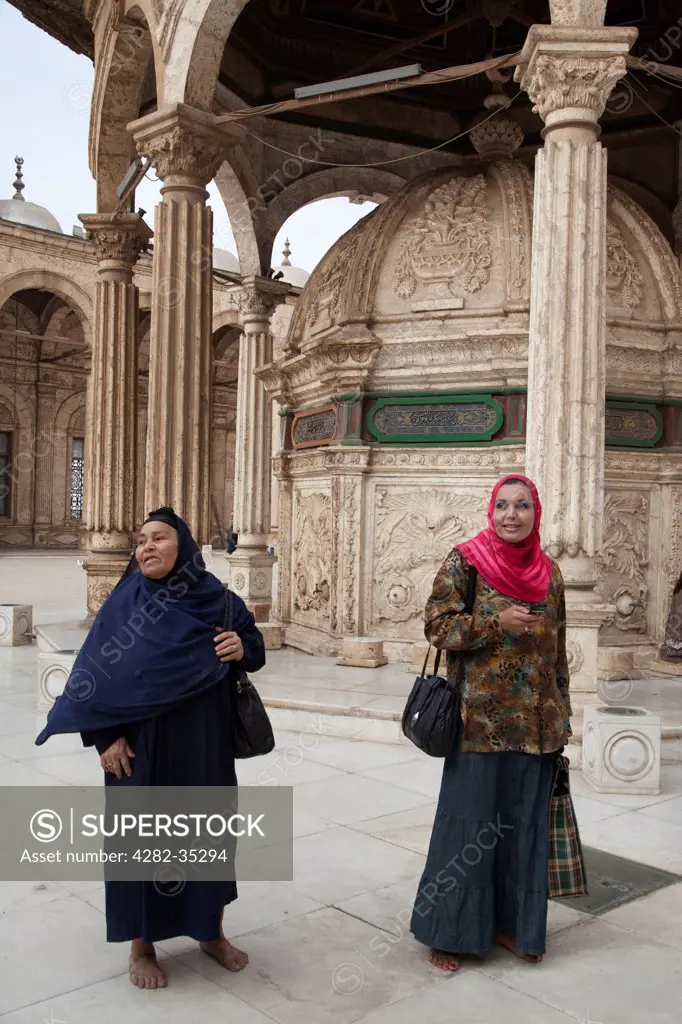 Egypt, Cairo, Cairo. Two women in the Muhammad Ali Mosque in Cairo.