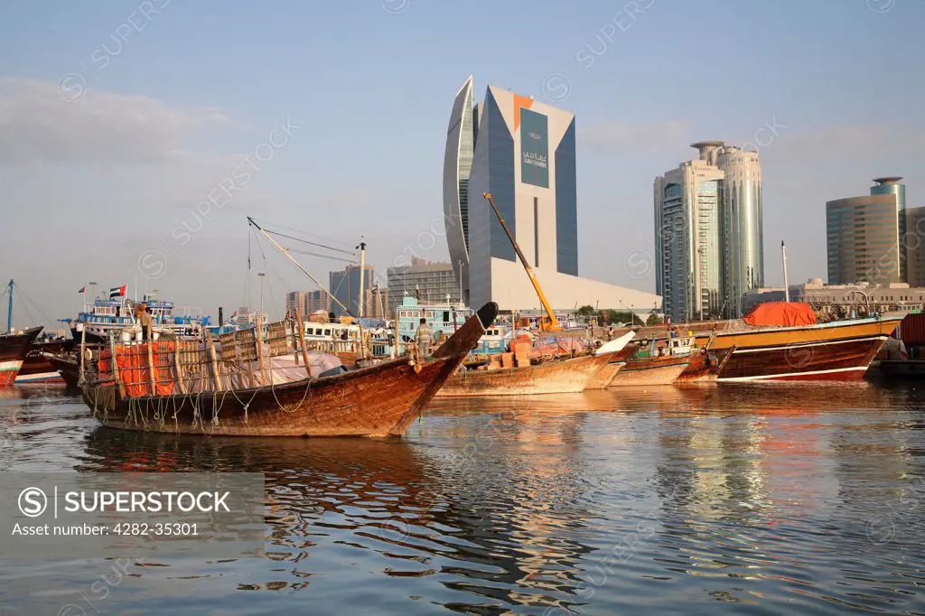 United Arab Emirates, Dubai, Dubai Creek. A boat trawls along Dubai Creek at dawn.