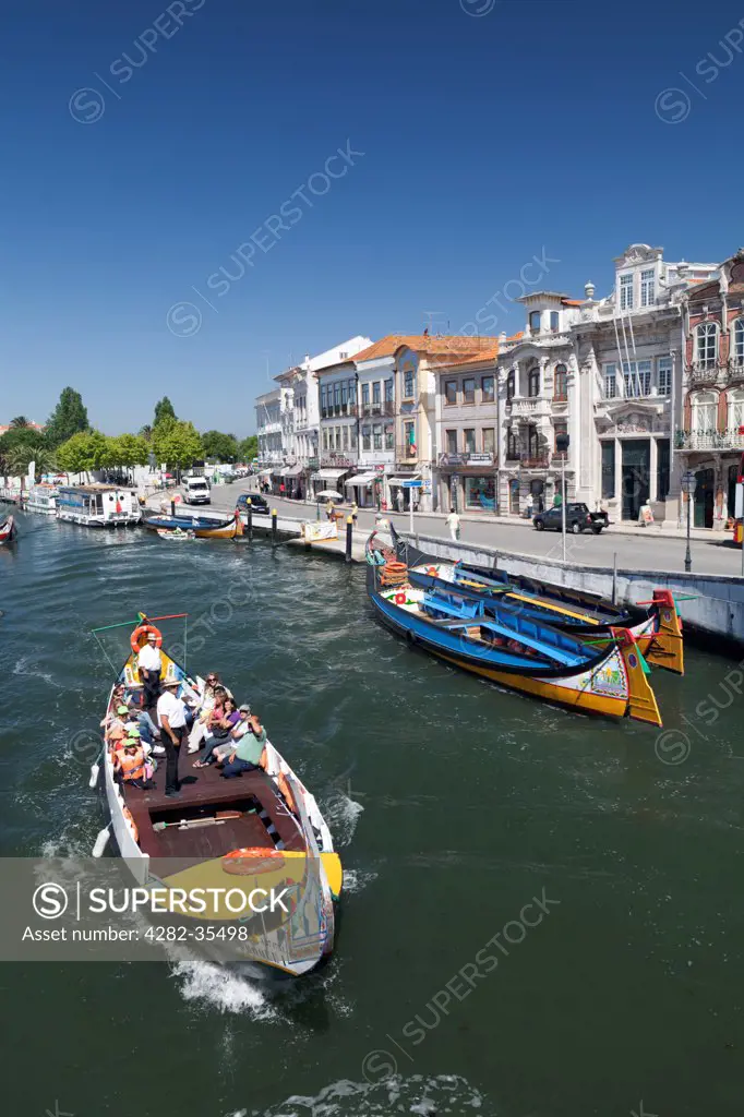 Portugal, Beira Litoral, Aveiro. Art Nouveau buildings and traditional moliceiros boats on the canal at Aveiro.