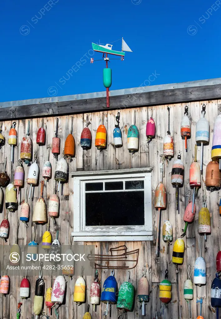 USA, Maine, Jonesport. A lobster shack decorated with colourful buoys in Jonesport.