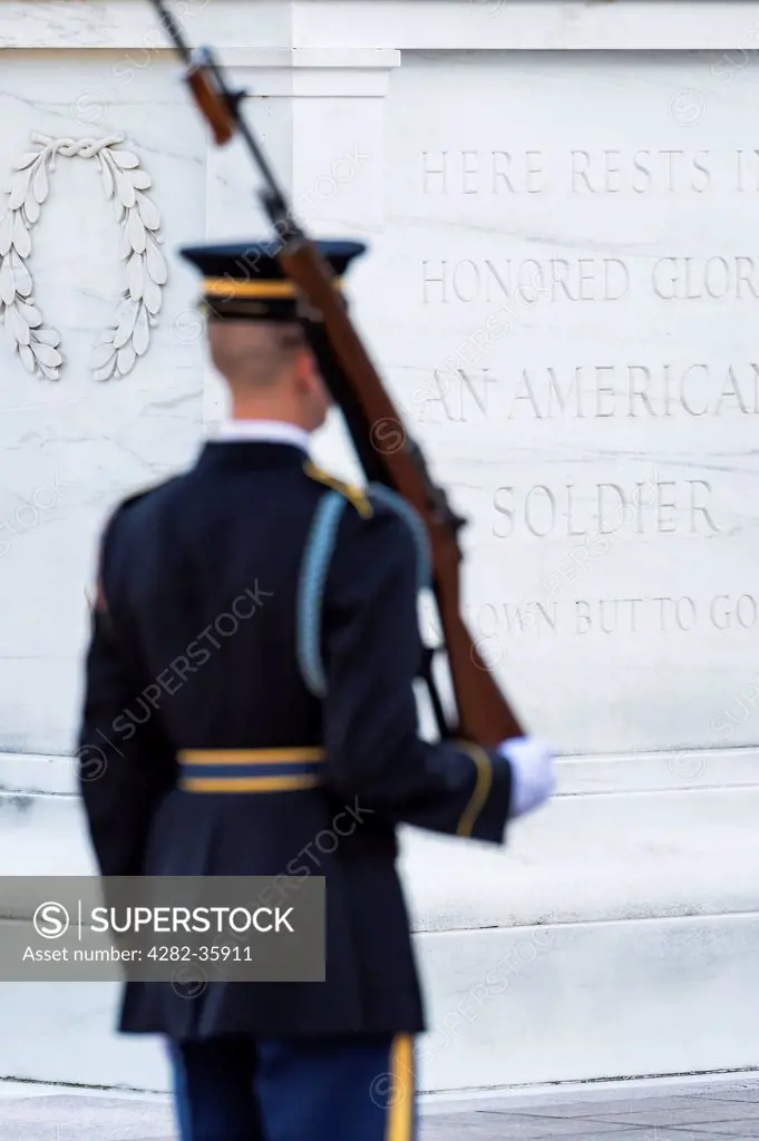 USA, Virginia, Arlington. An American military officer passes the Guarded Tomb of the Unknown Soldier in Arlington Cemetery.