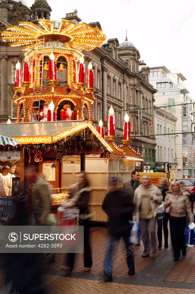 England, West Midlands, Birmingham. Christmas lights along New Street with the German Christmas market stalls.