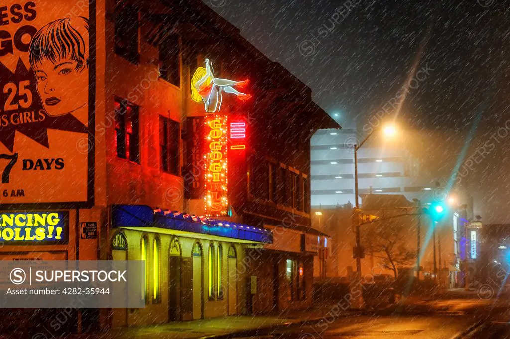 USA, New Jersey, Atlantic City. The neon lights of a strip club shine through the rain.
