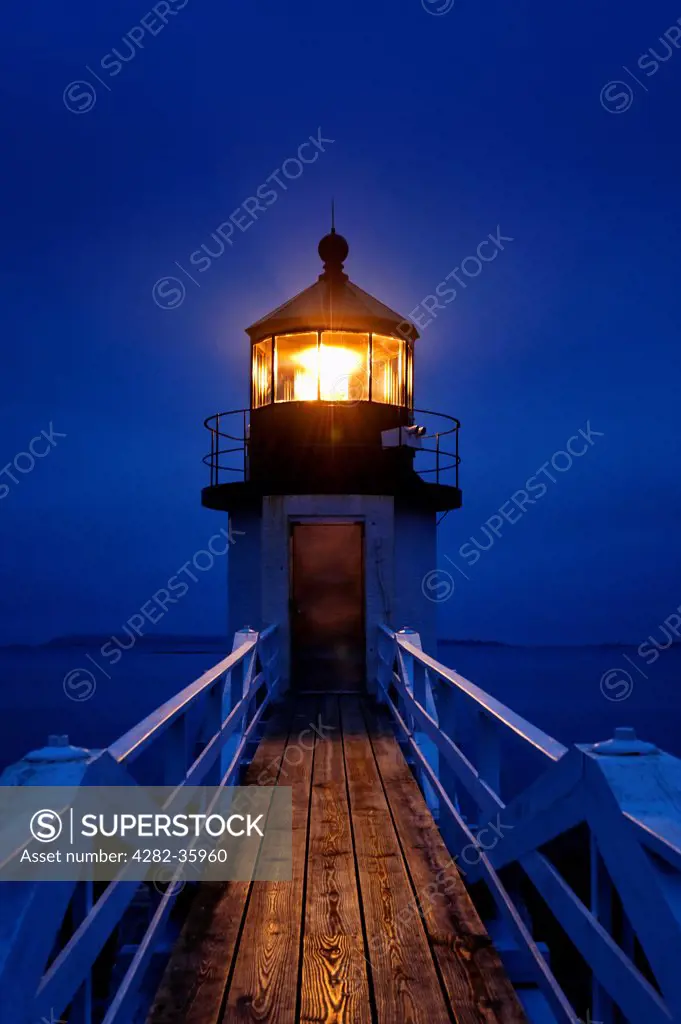 USA, Maine, Port Clyde. Marshall Point Light Station glowing at night in Port Clyde.