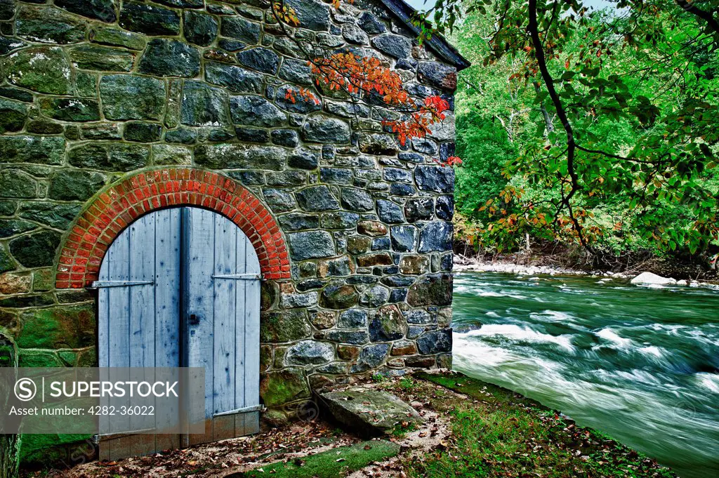 USA, Delaware, Wilmington. A wooden door and stone wall at Hagley Museum in Wilmington.