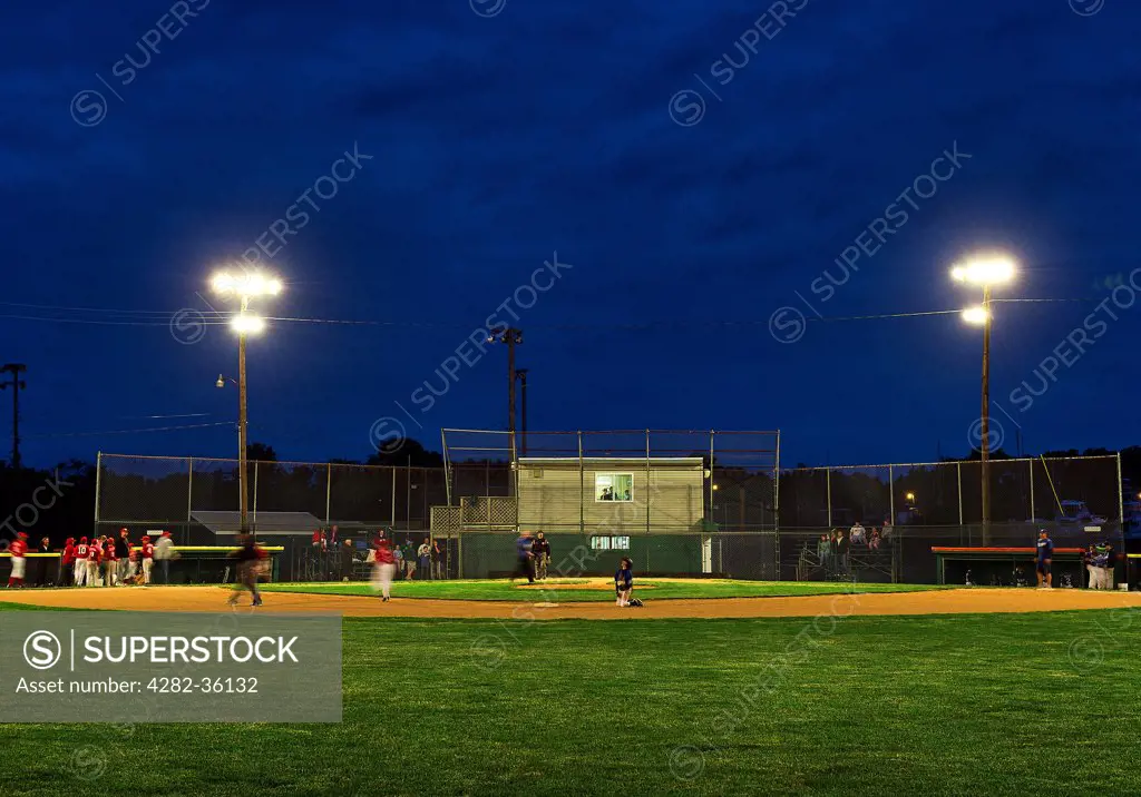 USA, Delaware, Lewes. A Little League baseball game at night.