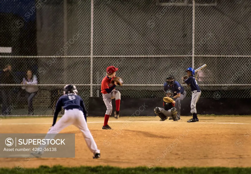 USA, Delaware, Milton. A Little League baseball game at night.