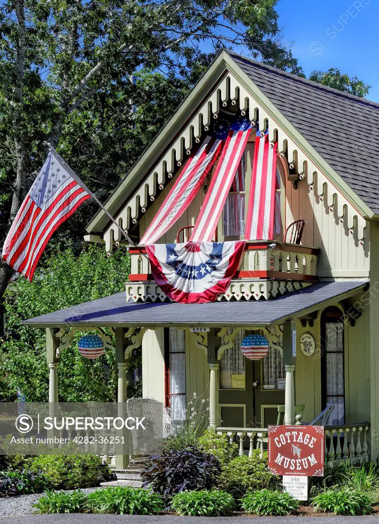 USA, Massachusetts, Marthas Vineyard. The Cottage Museum in Oak Bluffs decorated with the American flag.