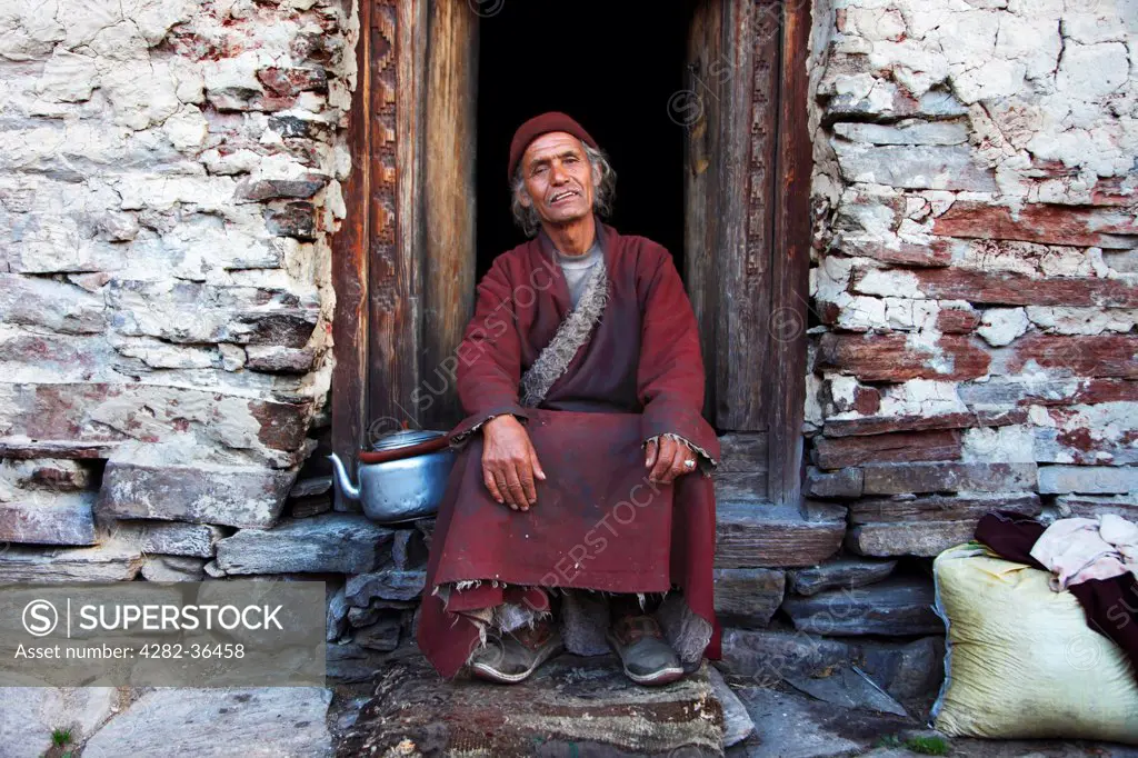 Nepal, Manang , Samagaon. A Buddhist monk at the doorstep of the temple.